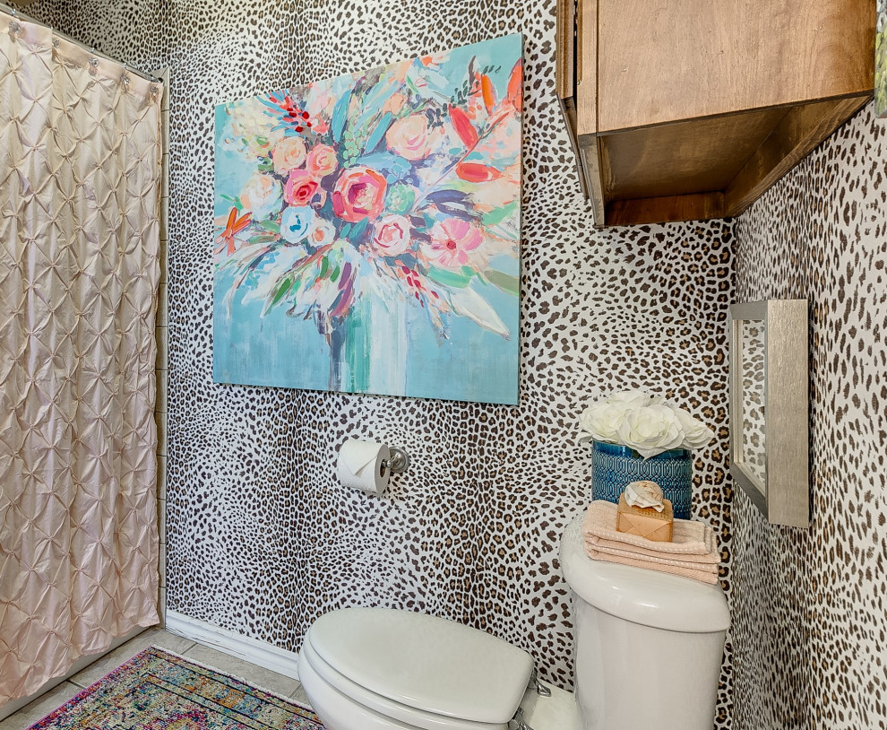 Small eclectic bathroom in Oklahoma City with a two-piece toilet, brown walls and grey floor.