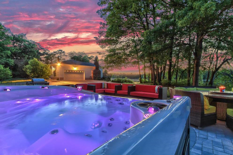 Example of a mid-sized trendy backyard brick and rectangular aboveground hot tub design in Chicago