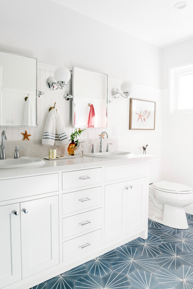 Inspiration for a beach style bathroom in Other with shaker cabinets, white cabinets, white walls, a drop-in sink, blue floor and white benchtops.