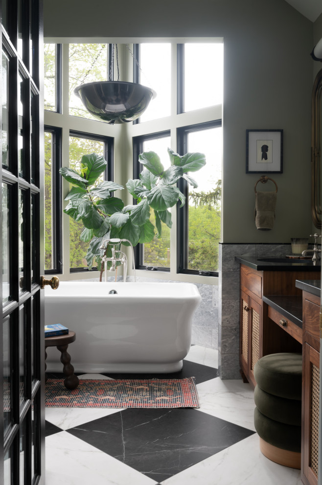 Freestanding bathtub - mid-sized transitional master green tile and marble tile marble floor, double-sink and vaulted ceiling freestanding bathtub idea in DC Metro with louvered cabinets, medium tone wood cabinets, green walls, an undermount sink, marble countertops, a hinged shower door, black countertops and a built-in vanity