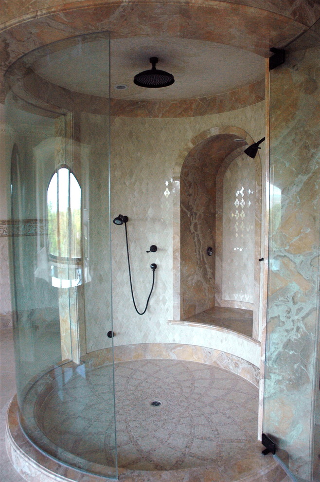 This is an example of an expansive mediterranean master bathroom in Los Angeles with marble benchtops, beige tile, beige walls, marble floors, furniture-like cabinets, dark wood cabinets, an alcove tub, a corner shower, stone slab and a console sink.