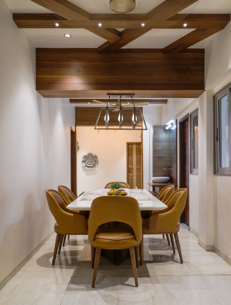 Mid-sized contemporary dining room in Ahmedabad with beige walls and beige floor.