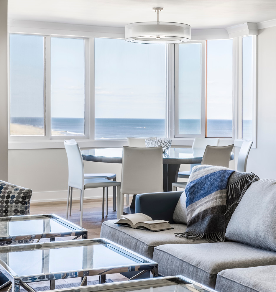 Design ideas for a mid-sized beach style open plan dining in New York with grey walls and light hardwood floors.