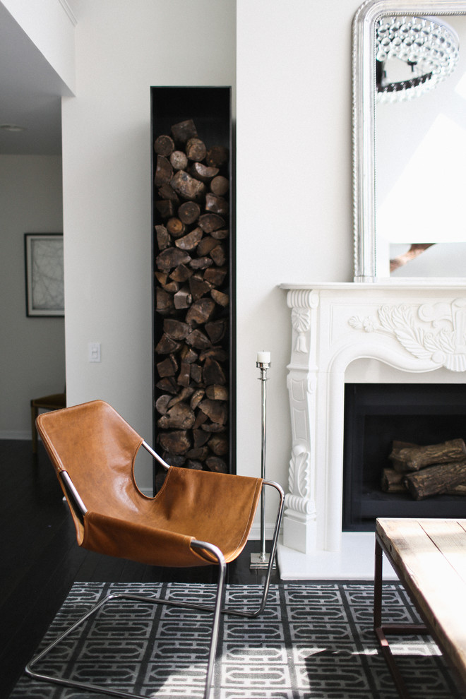 This is an example of a transitional living room in San Francisco with white walls, a standard fireplace and dark hardwood floors.