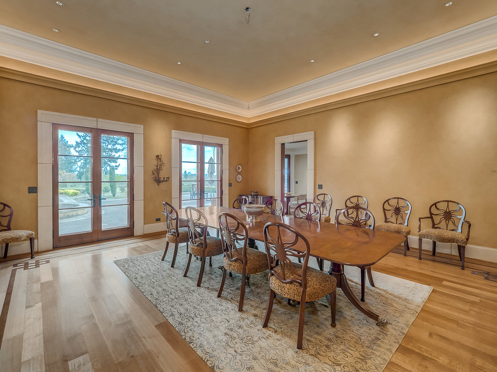 Photo of a large traditional separate dining room in Portland with brown walls, medium hardwood floors, no fireplace and brown floor.