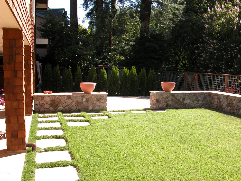 Photo of a mid-sized traditional backyard full sun garden in San Francisco with a water feature and natural stone pavers.