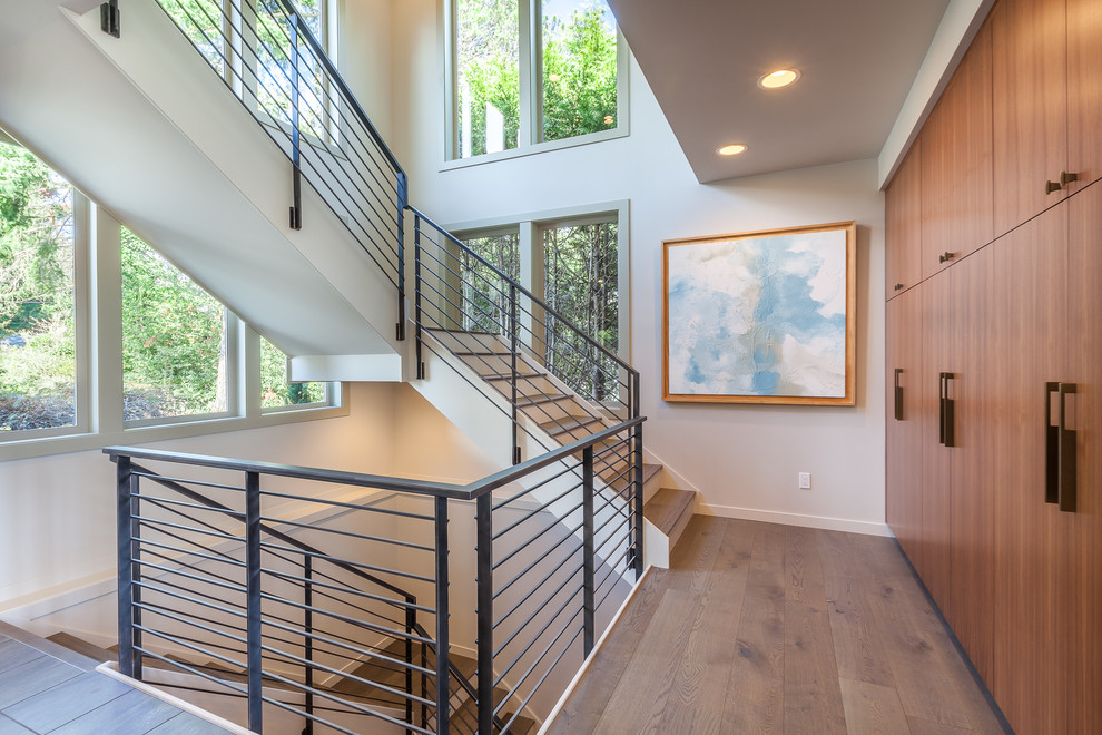 This is an example of a transitional wood l-shaped staircase in Seattle with painted wood risers.