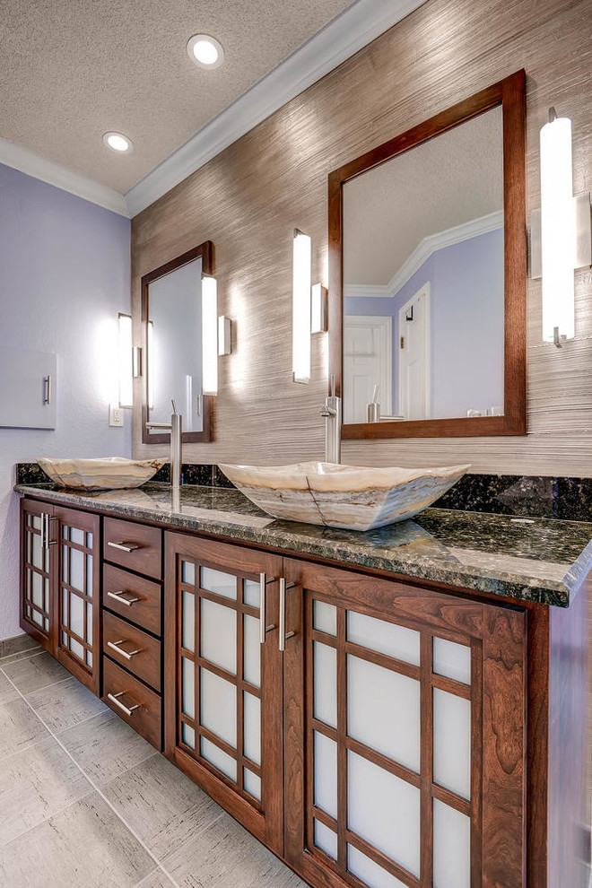 This is an example of a large asian master bathroom in Denver with a vessel sink, shaker cabinets, medium wood cabinets, granite benchtops, a corner shower, a two-piece toilet, gray tile, ceramic tile, purple walls and ceramic floors.