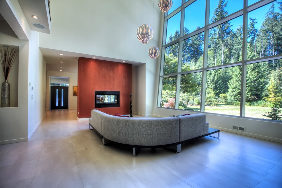 Large modern formal open concept living room in Seattle with white walls, porcelain floors, a two-sided fireplace, a metal fireplace surround and no tv.