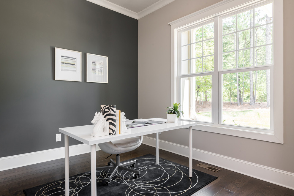 Design ideas for a mid-sized arts and crafts home office in Charlotte with grey walls, dark hardwood floors, no fireplace, brown floor and a freestanding desk.