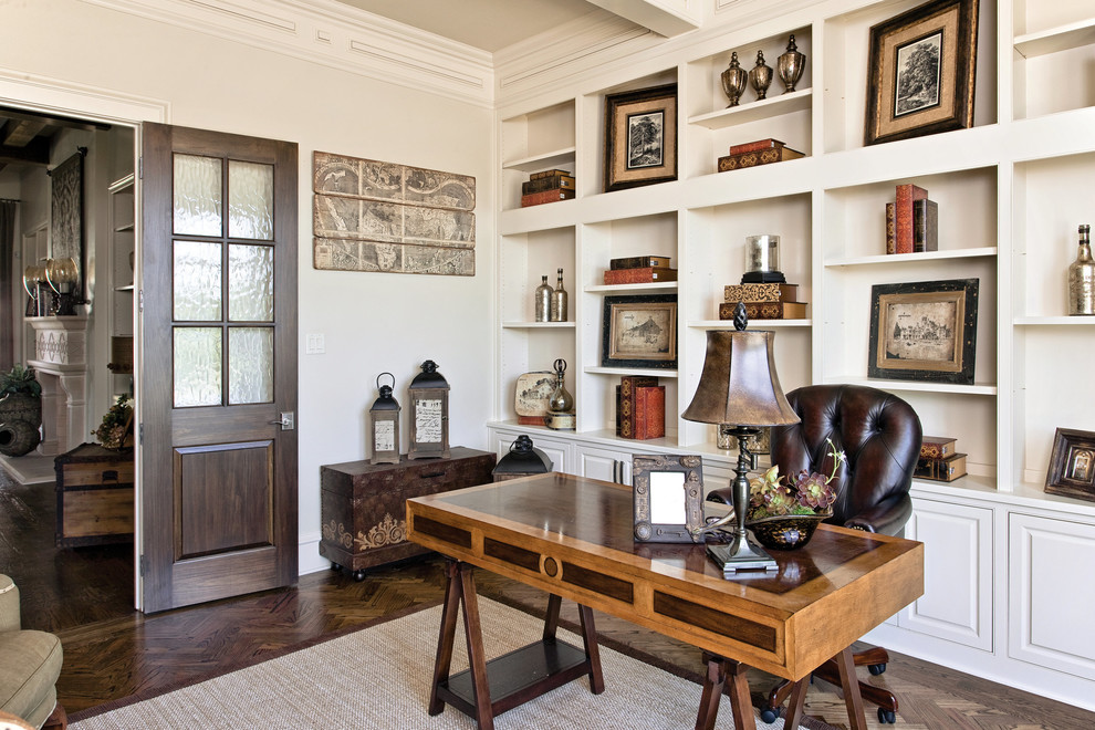 Traditional study room in Dallas with white walls, dark hardwood floors, a freestanding desk and brown floor.