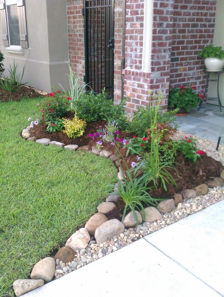 This is an example of a small contemporary front yard partial sun garden for spring in New Orleans with a garden path and mulch.