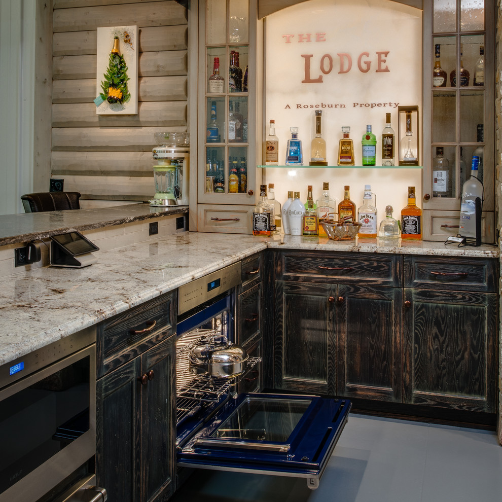 Inspiration for a rustic u-shaped concrete floor kitchen pantry remodel with a farmhouse sink, distressed cabinets, granite countertops, stainless steel appliances, white backsplash, subway tile backsplash, recessed-panel cabinets and an island