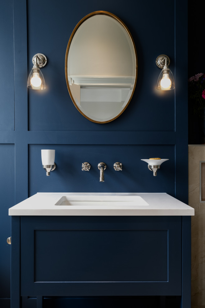 Bathroom - large traditional master blue tile and terra-cotta tile single-sink, wall paneling, marble floor and white floor bathroom idea in London with shaker cabinets, blue cabinets, a wall-mount toilet, blue walls, an undermount sink, white countertops, a built-in vanity and quartz countertops