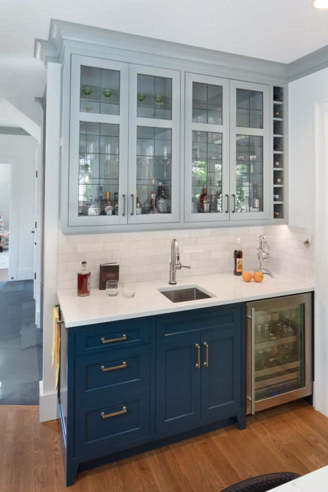 Mid-sized contemporary l-shaped eat-in kitchen in Seattle with an undermount sink, beaded inset cabinets, blue cabinets, quartz benchtops, white splashback, subway tile splashback, stainless steel appliances, medium hardwood floors, with island, brown floor, yellow benchtop and exposed beam.