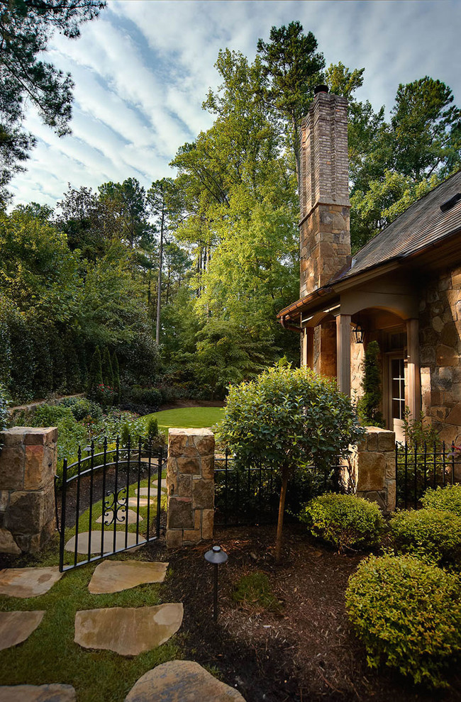 Photo of a mid-sized country side yard formal garden in Raleigh with a container garden and natural stone pavers.