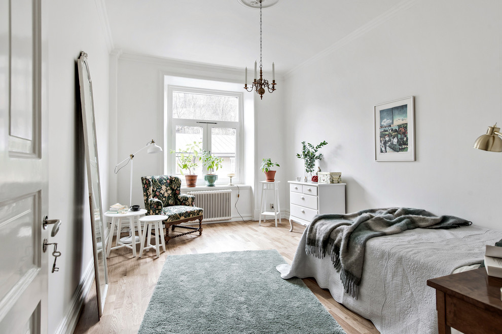 Mid-sized scandinavian bedroom in Gothenburg with white walls, light hardwood floors, beige floor and no fireplace.