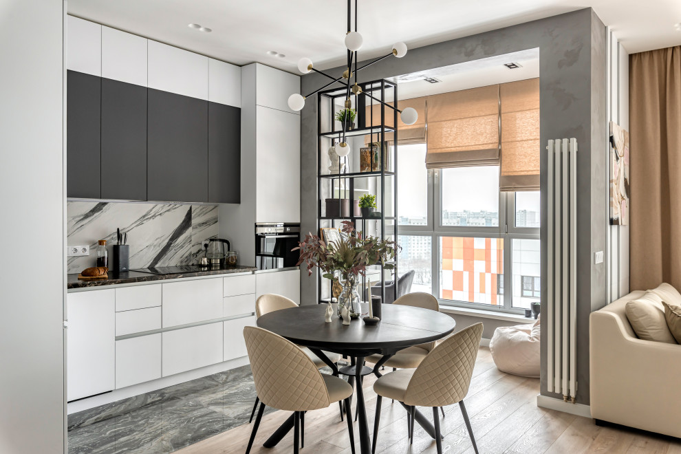 Aménagement d'une cuisine ouverte linéaire et grise et blanche scandinave de taille moyenne avec un placard à porte plane, un sol en carrelage de porcelaine et un sol noir.