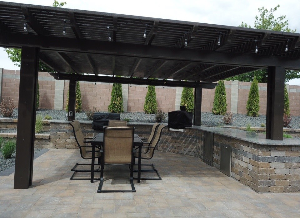 This is an example of a mid-sized modern backyard patio in Seattle with a fire feature and concrete pavers.