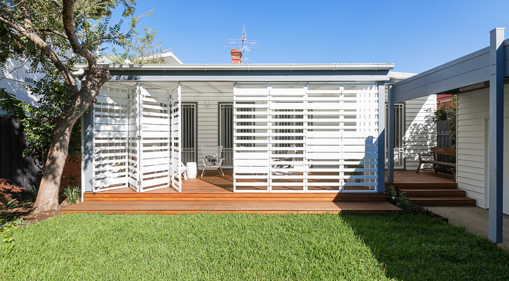 Design ideas for a small contemporary backyard screened-in verandah in Melbourne with decking and a roof extension.