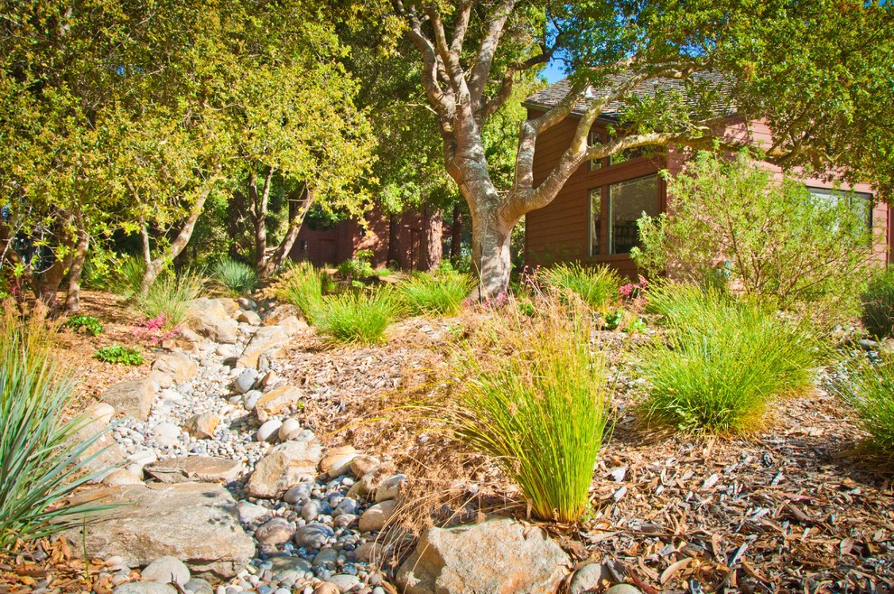 This is an example of a mediterranean backyard garden in San Luis Obispo with a water feature.