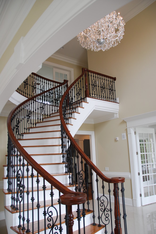 Design ideas for a traditional wood curved staircase in Raleigh.