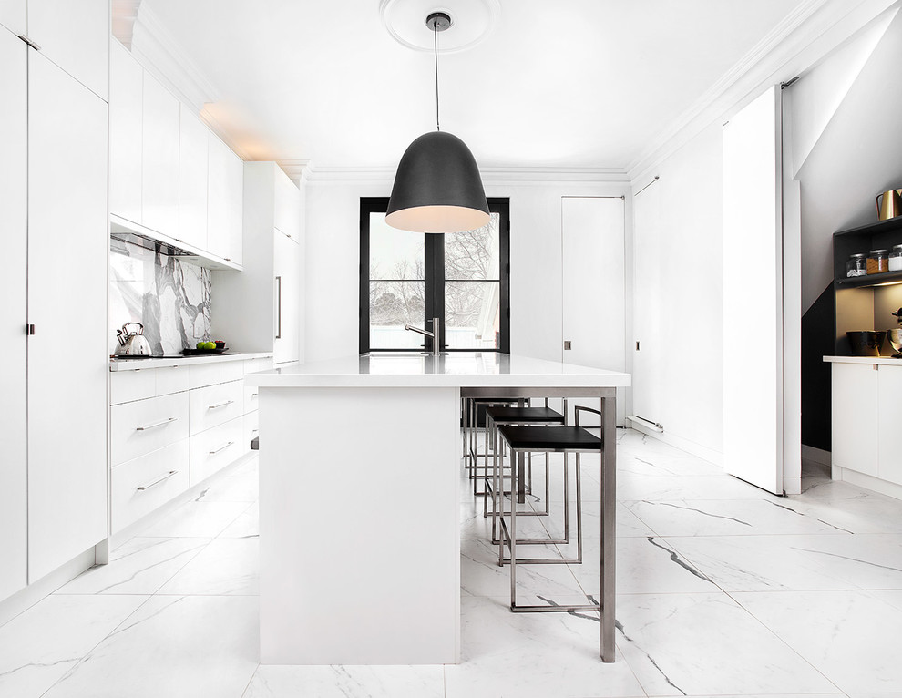 This is an example of a large contemporary single-wall kitchen pantry in Toronto with an undermount sink, flat-panel cabinets, white cabinets, quartz benchtops, white splashback, stone slab splashback, stainless steel appliances, porcelain floors and with island.