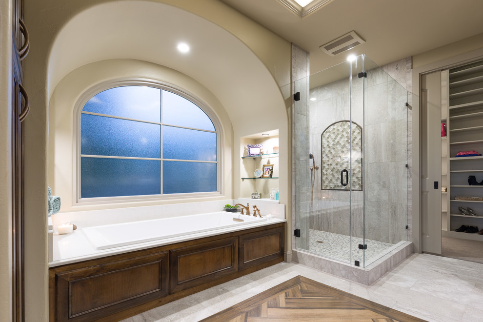 Example of a large transitional white tile and porcelain tile porcelain tile drop-in bathtub design in Austin with medium tone wood cabinets, beige walls, an undermount sink, quartz countertops and recessed-panel cabinets