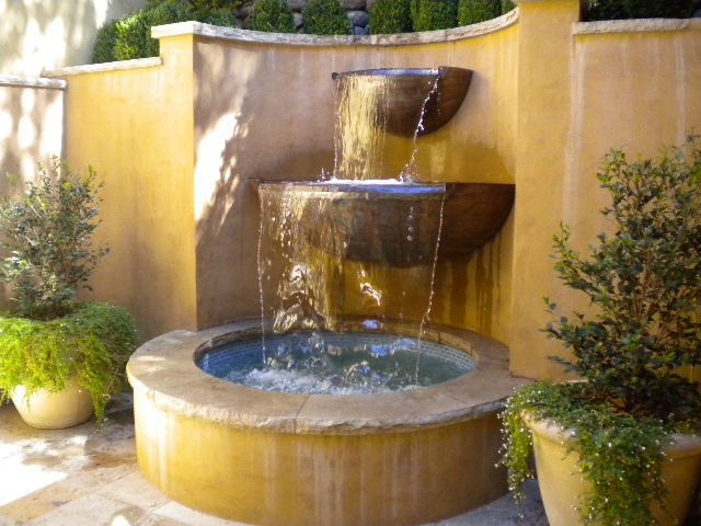 This is an example of a mid-sized mediterranean backyard garden in San Francisco with a water feature and natural stone pavers.
