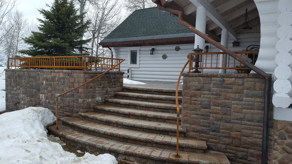 Example of a large mountain style backyard deck design with no cover