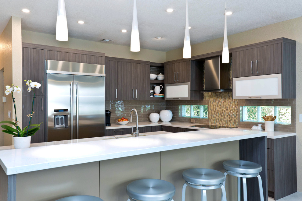 Design ideas for a mid-sized modern galley separate kitchen in Miami with an integrated sink, flat-panel cabinets, dark wood cabinets, solid surface benchtops, multi-coloured splashback, mosaic tile splashback, stainless steel appliances and a peninsula.