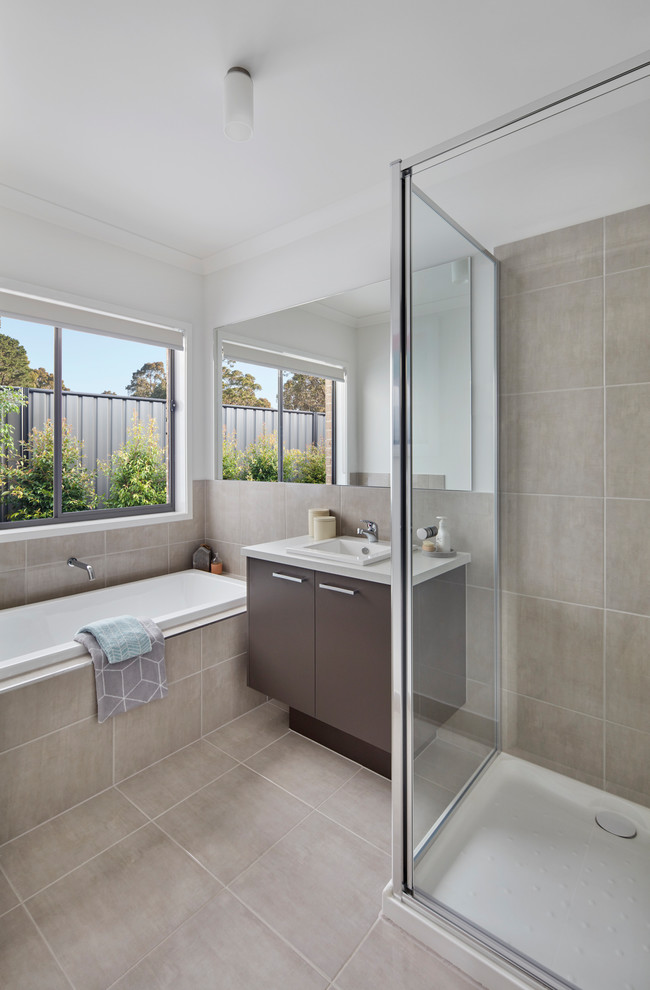 Inspiration for a contemporary master bathroom in Melbourne with flat-panel cabinets, brown cabinets, a drop-in tub, a corner shower, beige tile, beige walls, a drop-in sink and beige floor.