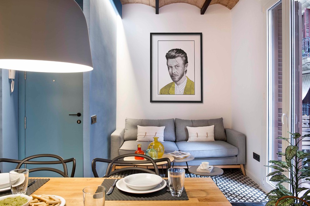 Small beach style open concept family room in Barcelona with multi-coloured walls and multi-coloured floor.