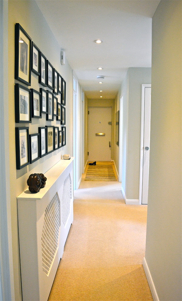 Design ideas for a contemporary hallway in London with beige walls and carpet.