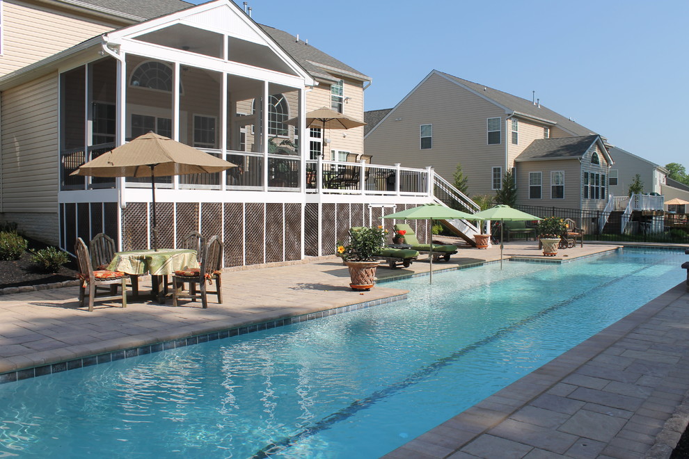 Example of a large transitional backyard concrete paver and rectangular lap pool fountain design in Baltimore