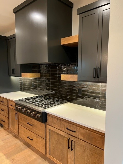 Mountain style kitchen photo with shaker cabinets and an island