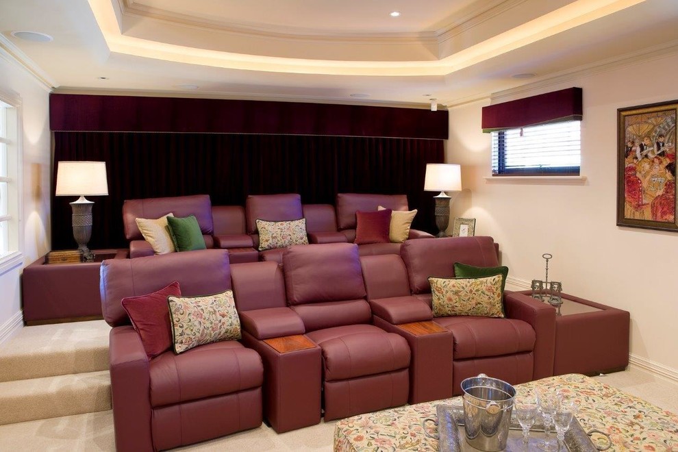 This is an example of a mediterranean enclosed home cinema in Perth with beige walls, carpet, a projector screen and beige floors.