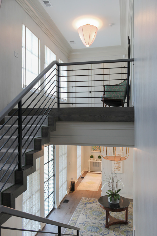Large eclectic wood floating staircase in DC Metro with wood risers and metal railing.