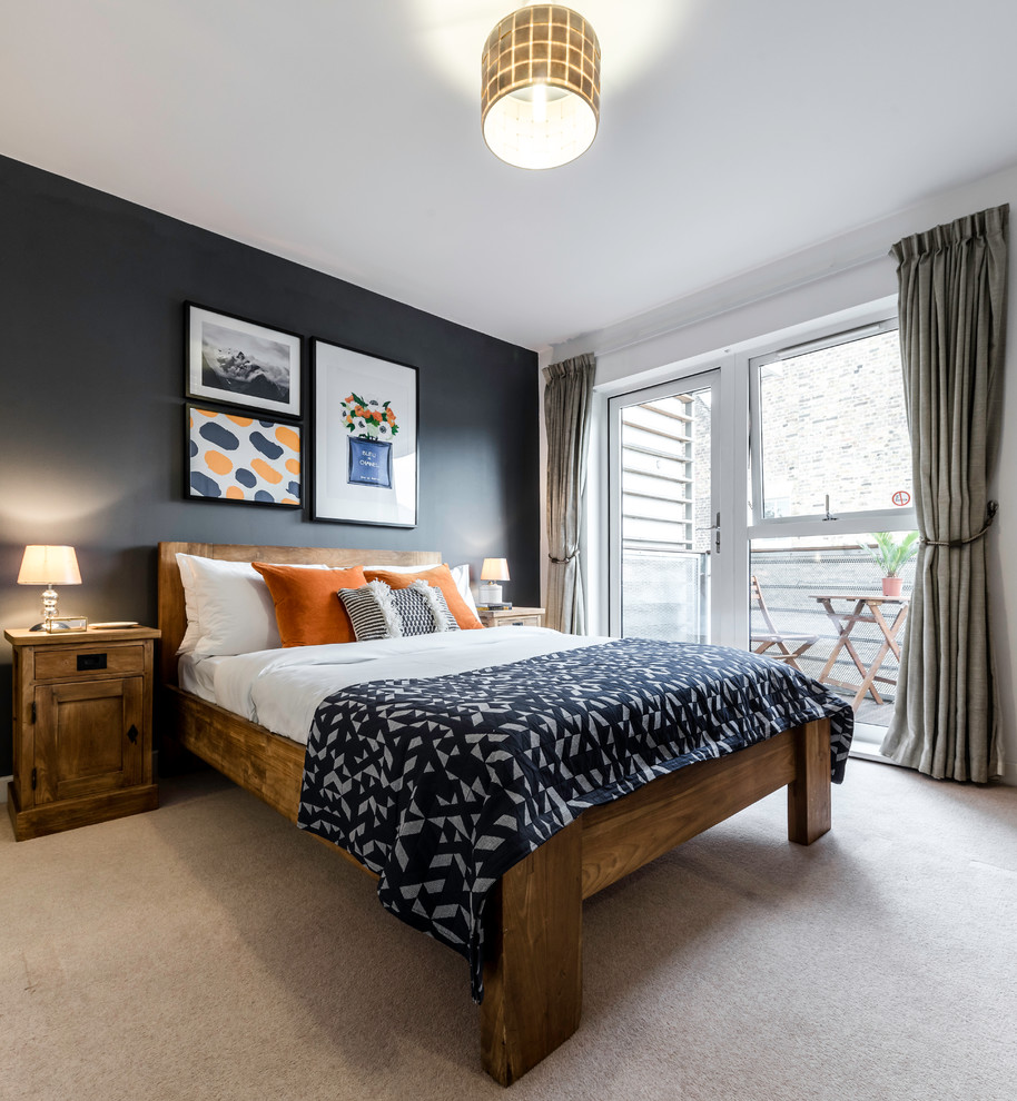 This is an example of a rustic bedroom in London with black walls, carpet, feature lighting and a feature wall.