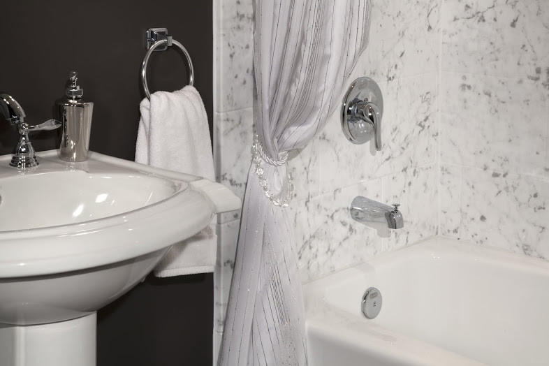 Photo of a mid-sized traditional master bathroom in Other with an alcove tub, an alcove shower, a two-piece toilet, gray tile, white tile, stone tile, grey walls and a pedestal sink.