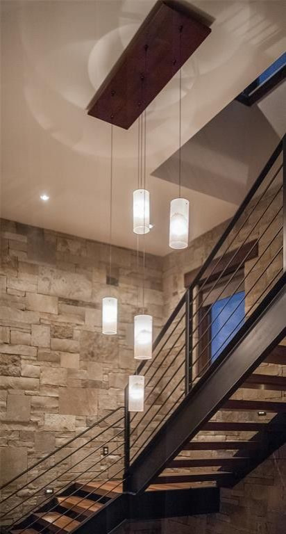 Example of a mid-sized transitional wooden u-shaped open and metal railing staircase design