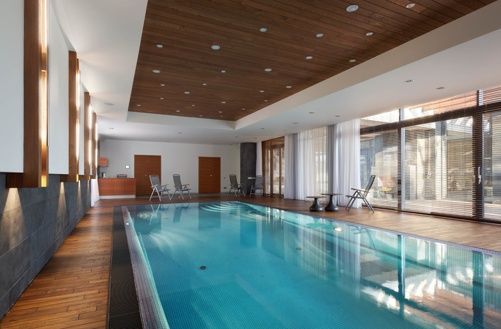 Design ideas for a large contemporary indoor rectangular lap pool in Moscow with decking.