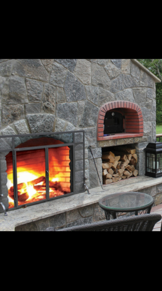 Example of a large transitional backyard deck design in Bridgeport with a fire pit and no cover