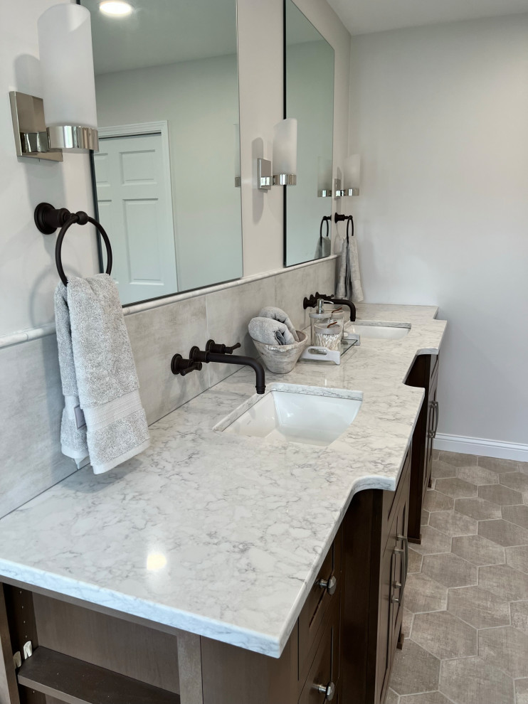Inspiration for a large transitional master white tile and porcelain tile porcelain tile, gray floor and double-sink freestanding bathtub remodel in Cincinnati with medium tone wood cabinets, white walls, an undermount sink, quartz countertops, a hinged shower door, white countertops and a built-in vanity