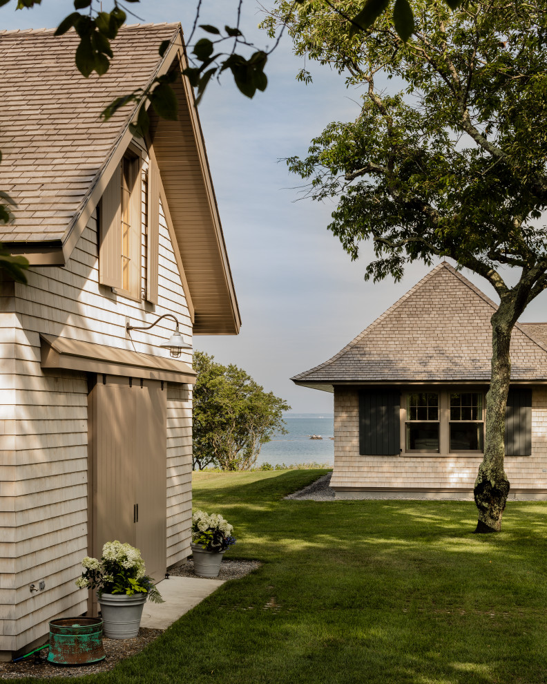 Inspiration for a coastal two-story wood house exterior remodel in Boston with a shingle roof