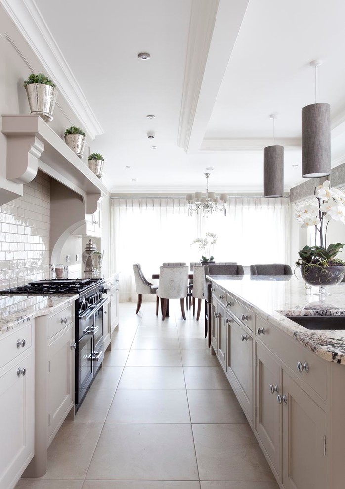 Design ideas for a large transitional open plan kitchen in Other with an integrated sink, beaded inset cabinets, grey cabinets, granite benchtops, beige splashback, subway tile splashback, panelled appliances, ceramic floors and with island.
