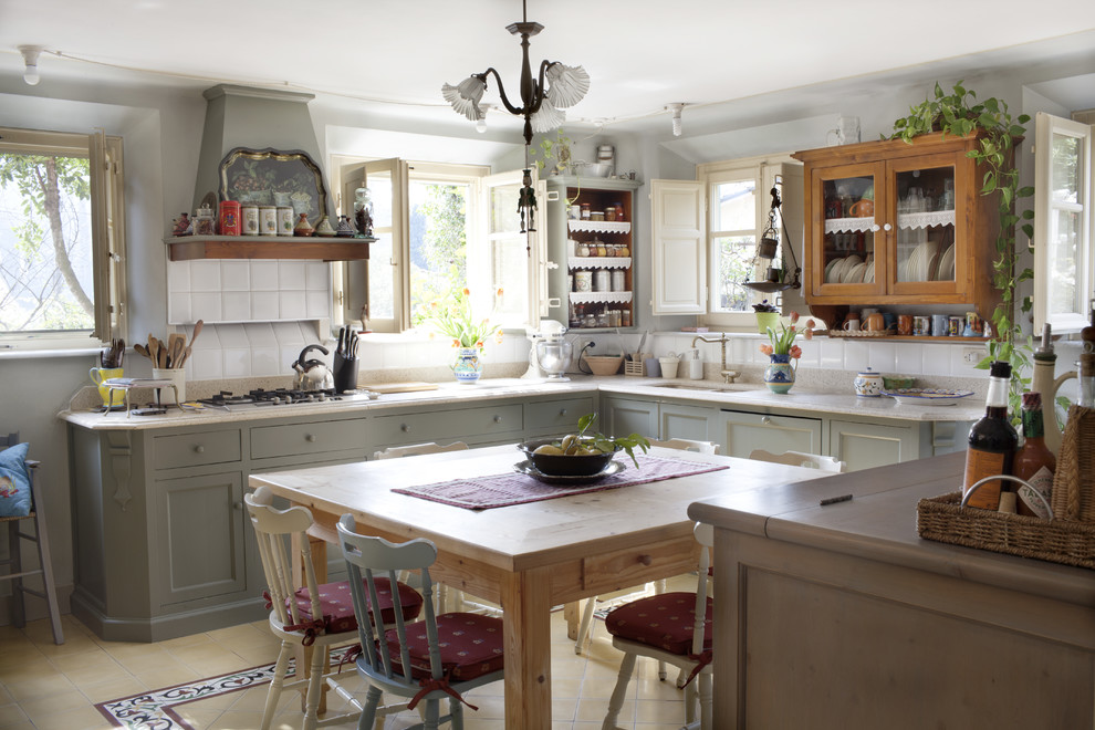 Inspiration for a country u-shaped eat-in kitchen in Florence with an undermount sink, recessed-panel cabinets, grey cabinets, white splashback, no island, multi-coloured floor and white benchtop.
