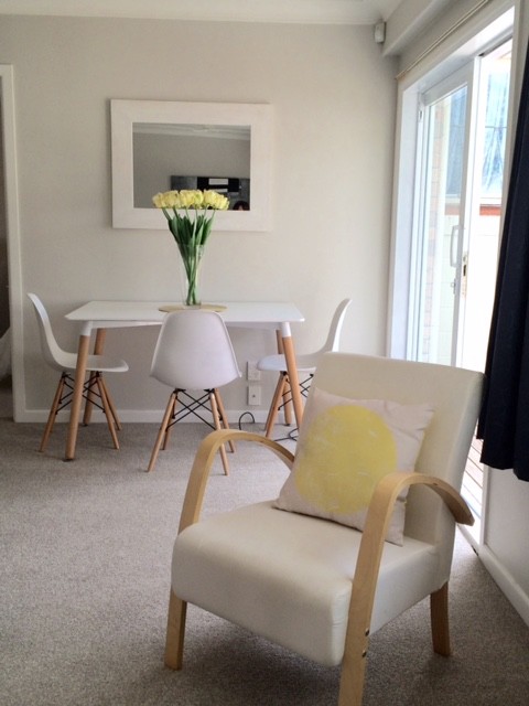 Inspiration for a small modern dining room in Auckland with carpet, no fireplace and grey floor.