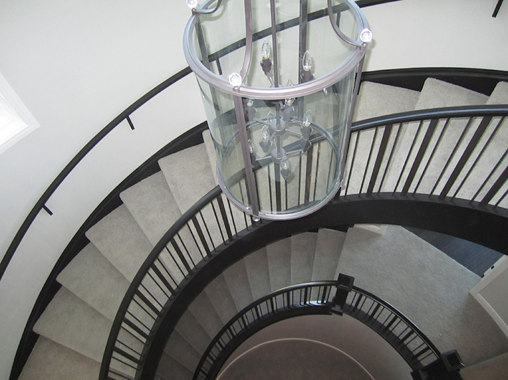 Inspiration for a large carpeted spiral staircase remodel in Calgary with carpeted risers