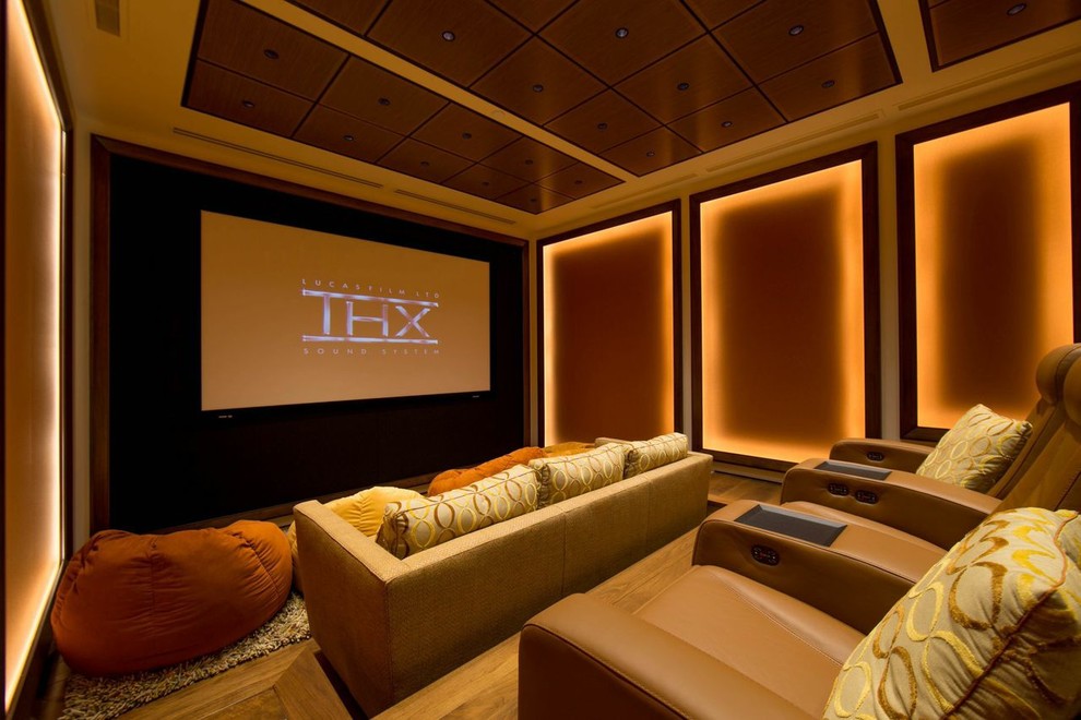 Photo of a large transitional enclosed home theatre in San Francisco with a projector screen, multi-coloured walls and medium hardwood floors.
